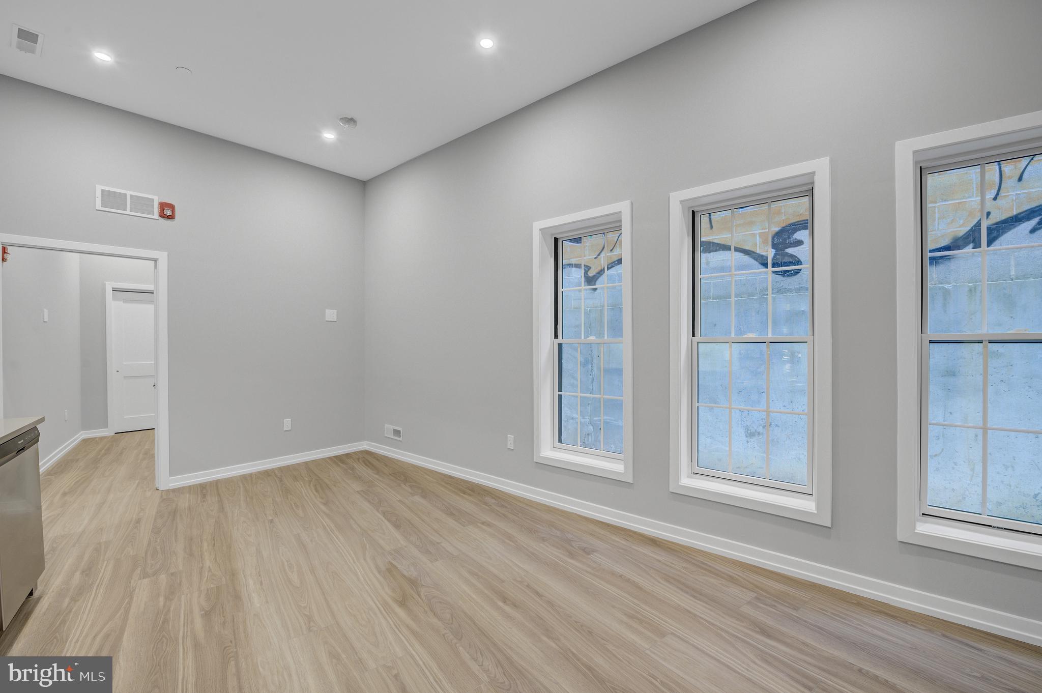 2445 Innovator Way, Unit 1A Philadelphia, PA 19146 - Photo 6 of 14 wooden floor in an empty room with a window