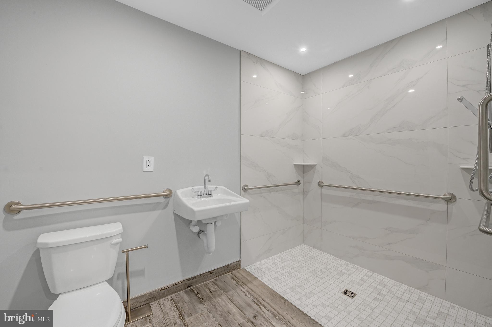 2445 Innovator Way, Unit 1A Philadelphia, PA 19146 - Photo 7 of 14 a bathroom with a sink a toilet and shower