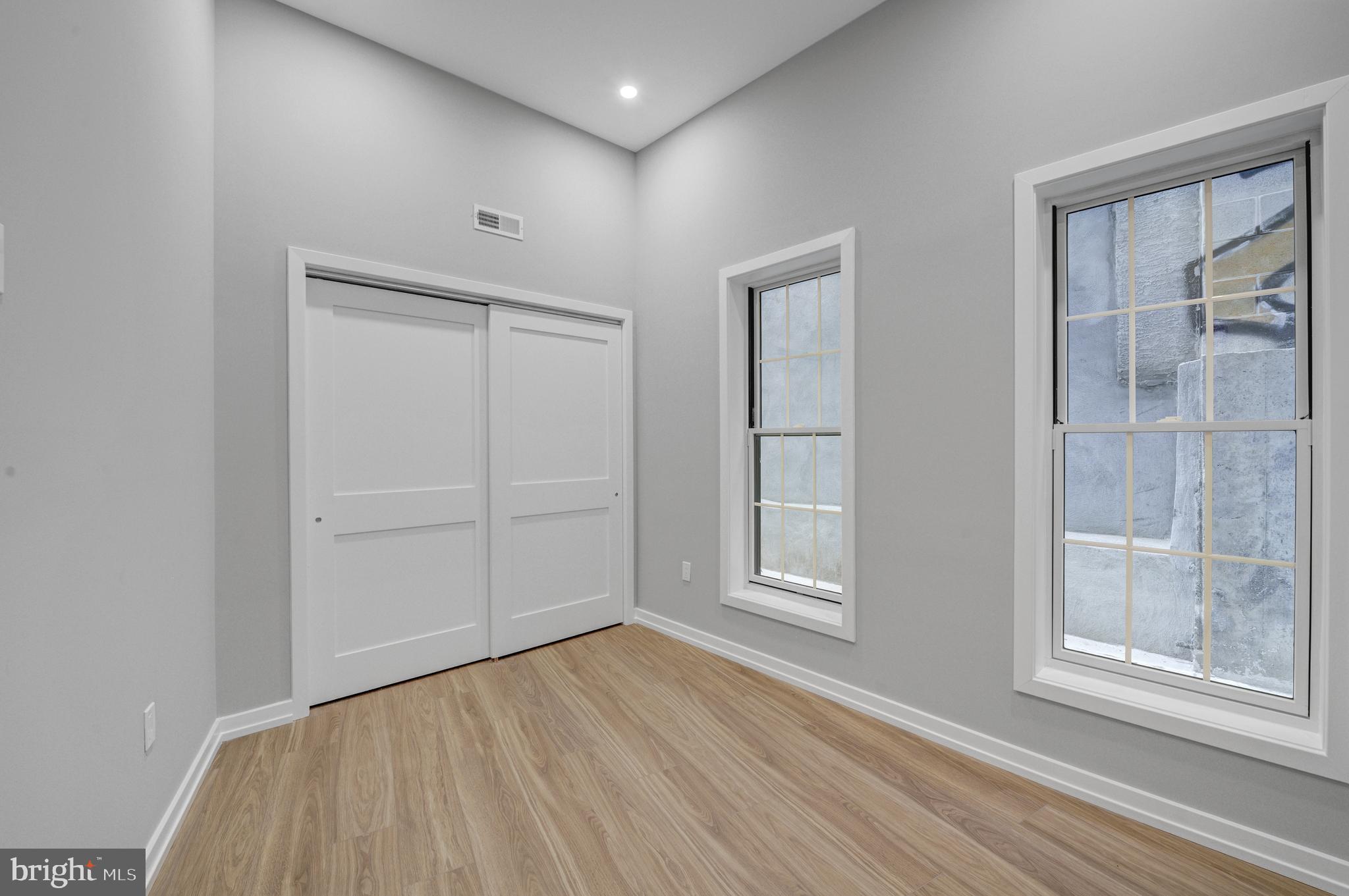 2445 Innovator Way, Unit 1A Philadelphia, PA 19146 - Photo 9 of 14 an empty room with wooden floor and windows