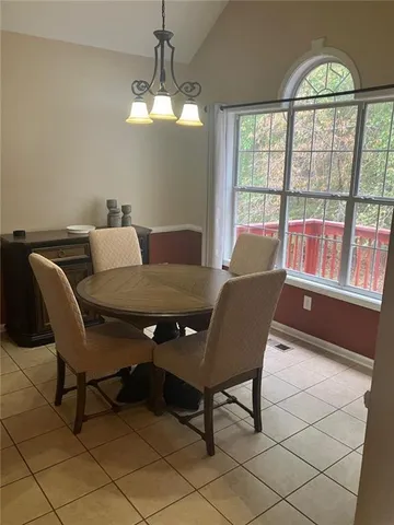 a view of a dining room with furniture wooden floor and chandelier