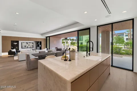 a kitchen with stainless steel appliances granite countertop sink stove and refrigerator