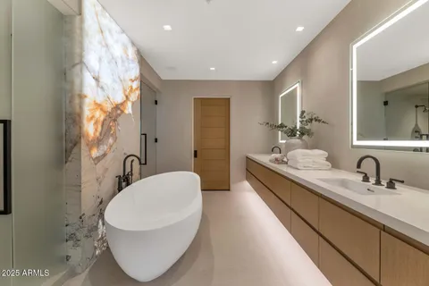 a bathroom with a double vanity sink mirror and toilet