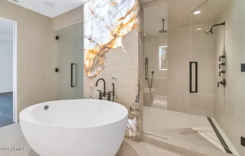 a white bath tub sitting next to a white tub