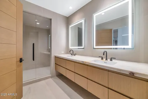 a bathroom with a granite countertop sink mirror and double