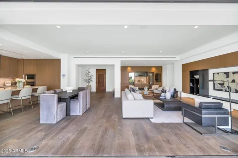 a living room with furniture dining table and a large window