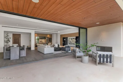 a living room with furniture and potted plants