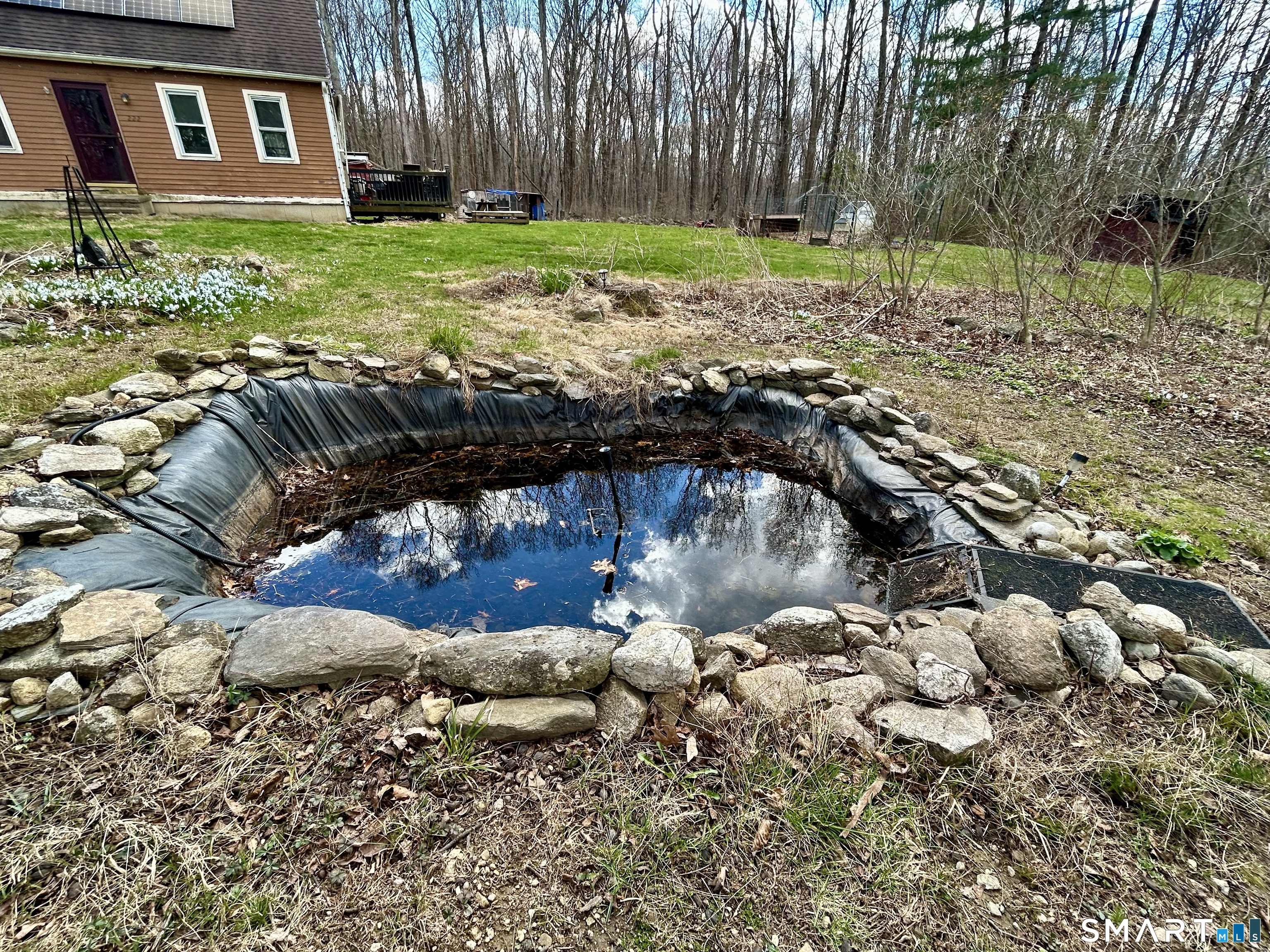 222 Parish Hill Road Scotland, CT 06264 - Photo 13 of 14 a backyard of a house with a yard and outdoor seating
