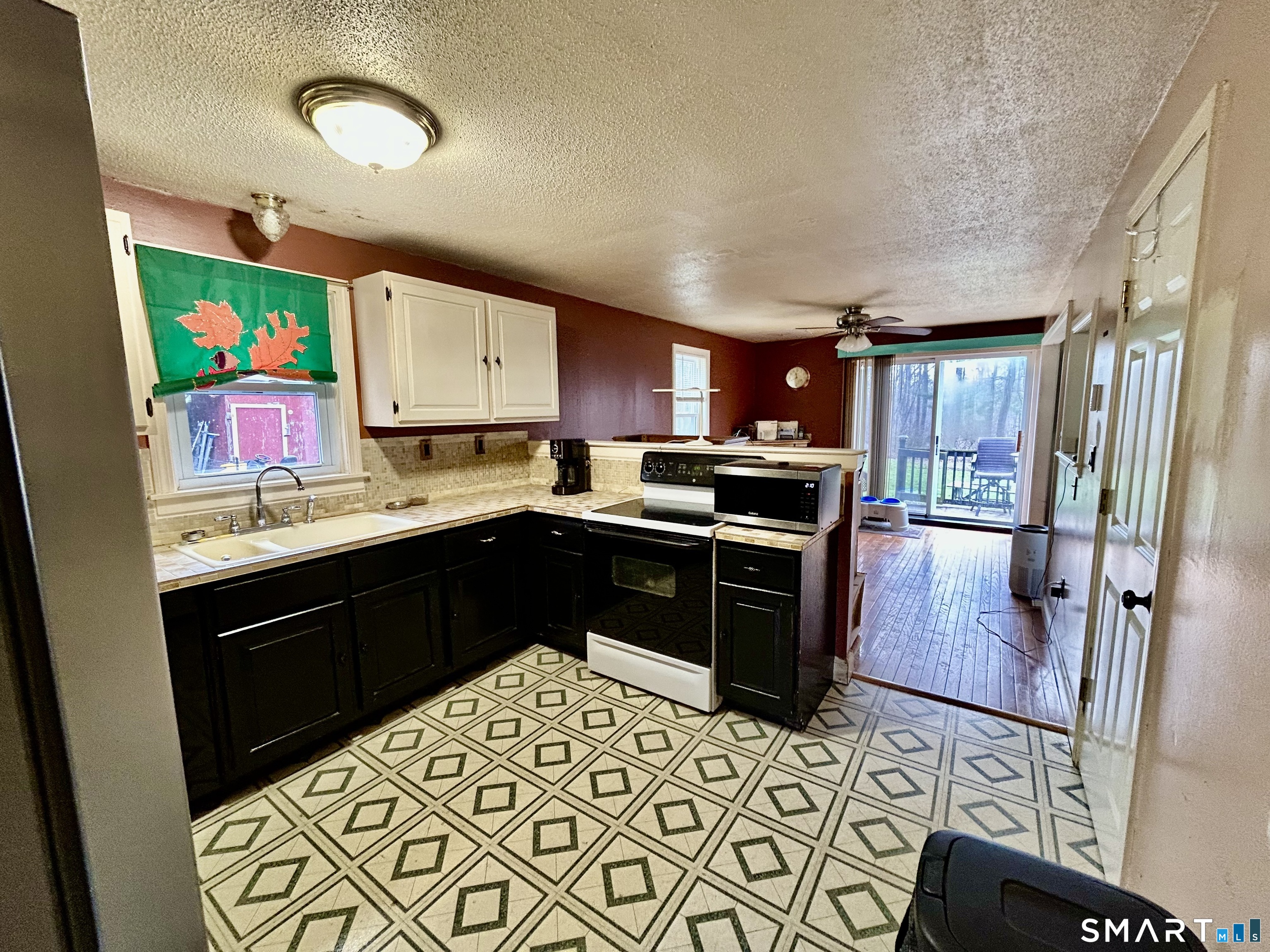 222 Parish Hill Road Scotland, CT 06264 - Photo 3 of 14 a kitchen with stainless steel appliances granite countertop a refrigerator stove top oven and sink