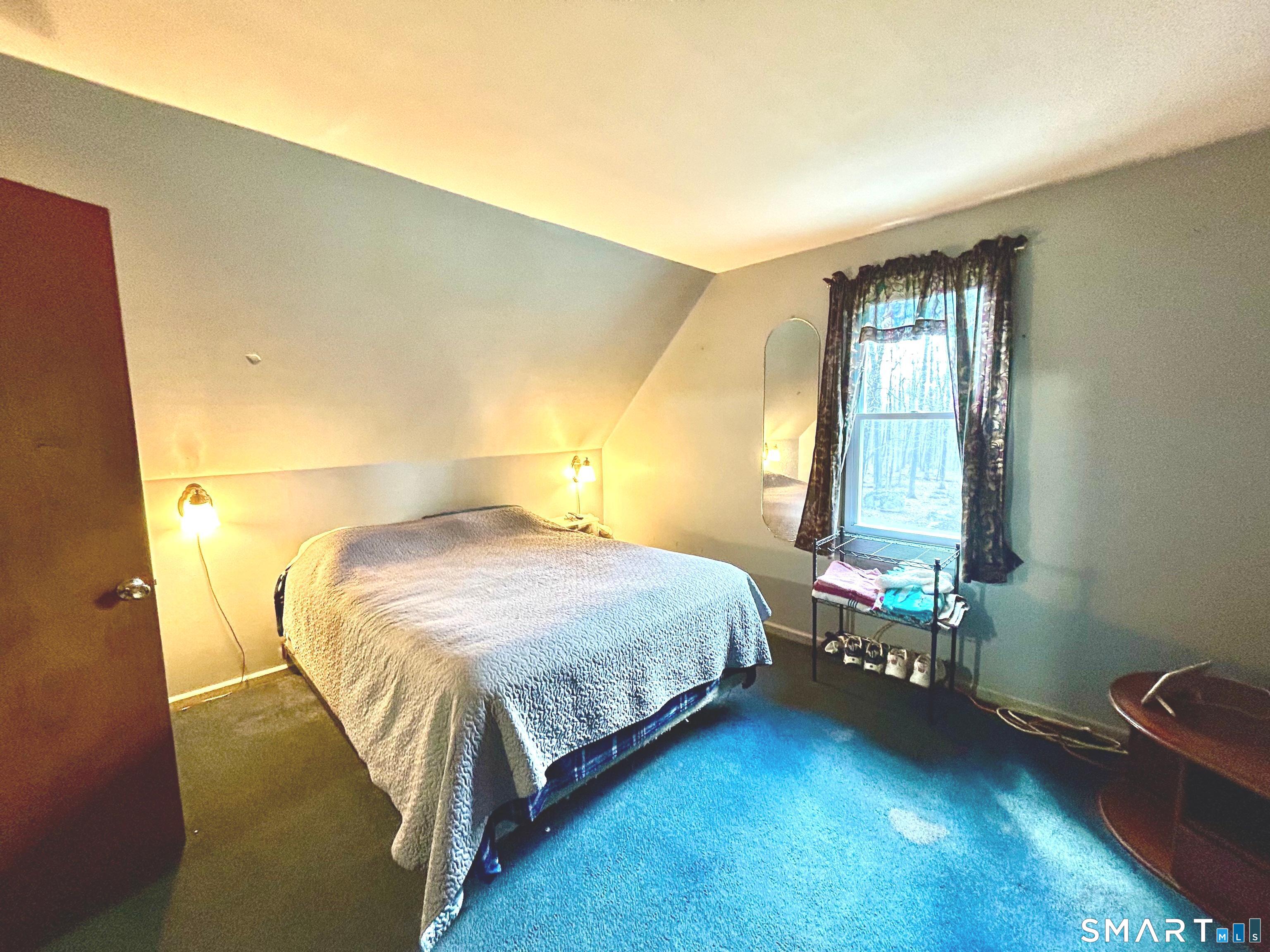 222 Parish Hill Road Scotland, CT 06264 - Photo 9 of 14 a bedroom with a bed and a window