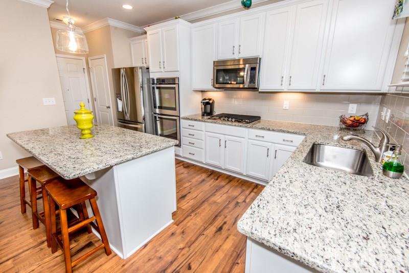 422 Plainview Avenue Raleigh, NC 27604 - Photo 2 of 25 a kitchen with stainless steel appliances granite countertop a sink stove microwave and refrigerator