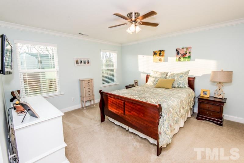 422 Plainview Avenue Raleigh, NC 27604 - Photo 13 of 25 a spacious bedroom with a bed and a chandelier