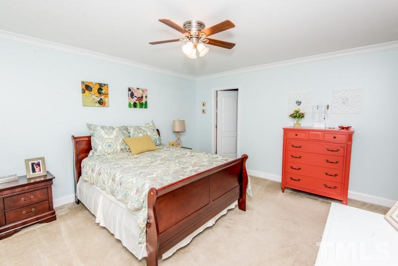 422 Plainview Avenue Raleigh, NC 27604 - Photo 14 of 25 a bedroom with a bed and a dresser in it