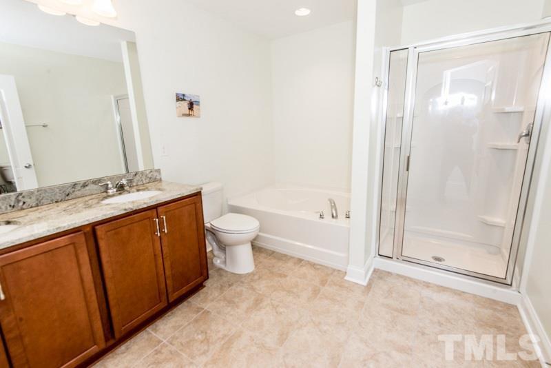 422 Plainview Avenue Raleigh, NC 27604 - Photo 15 of 25 a bathroom with a granite countertop sink a toilet and shower