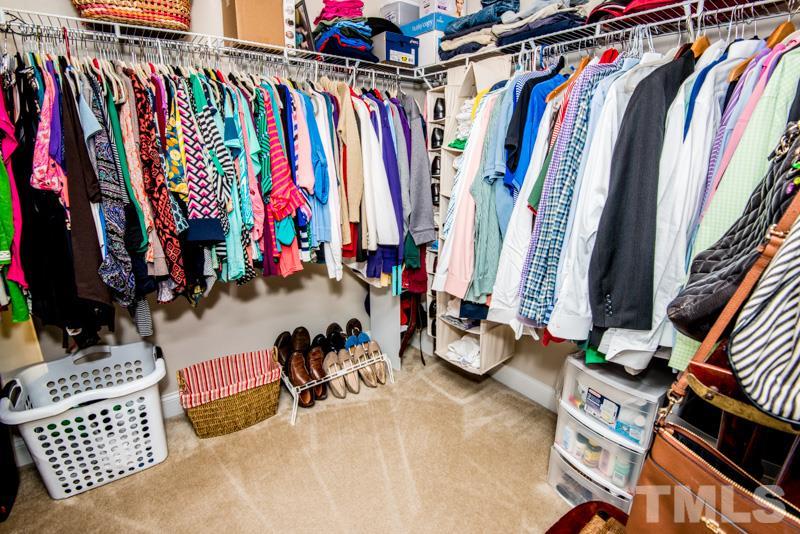 422 Plainview Avenue Raleigh, NC 27604 - Photo 16 of 25 a view of walk in closet with clothes and shoes