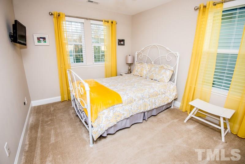422 Plainview Avenue Raleigh, NC 27604 - Photo 17 of 25 a spacious bedroom with a bed and wooden floor