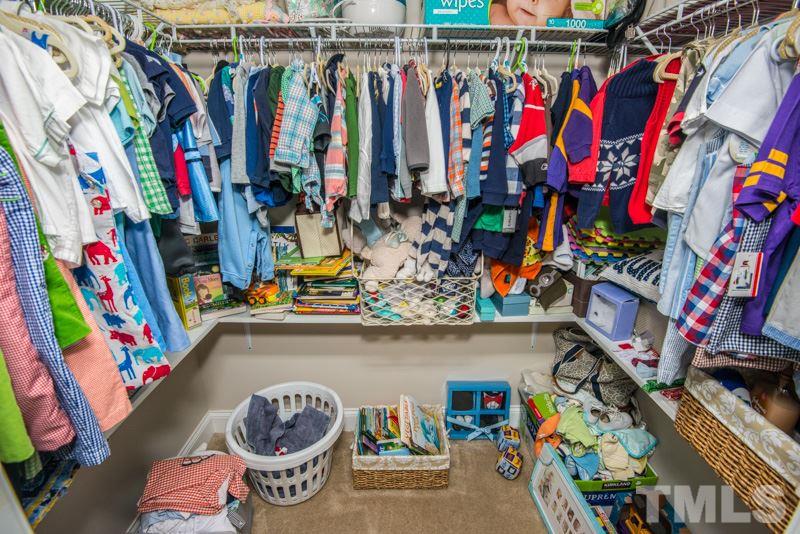 422 Plainview Avenue Raleigh, NC 27604 - Photo 19 of 25 a view of walk in closet with clothes and shoes