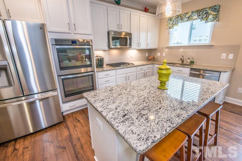 422 Plainview Avenue Raleigh, NC 27604 - Photo 4 of 25 a kitchen with stainless steel appliances granite countertop a refrigerator sink and stove
