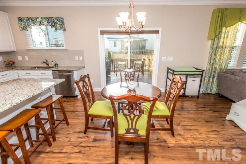 422 Plainview Avenue Raleigh, NC 27604 - Photo 8 of 25 a view of a dining room with furniture and wooden floor