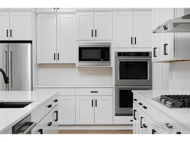 a kitchen with stainless steel appliances white cabinets and a stove