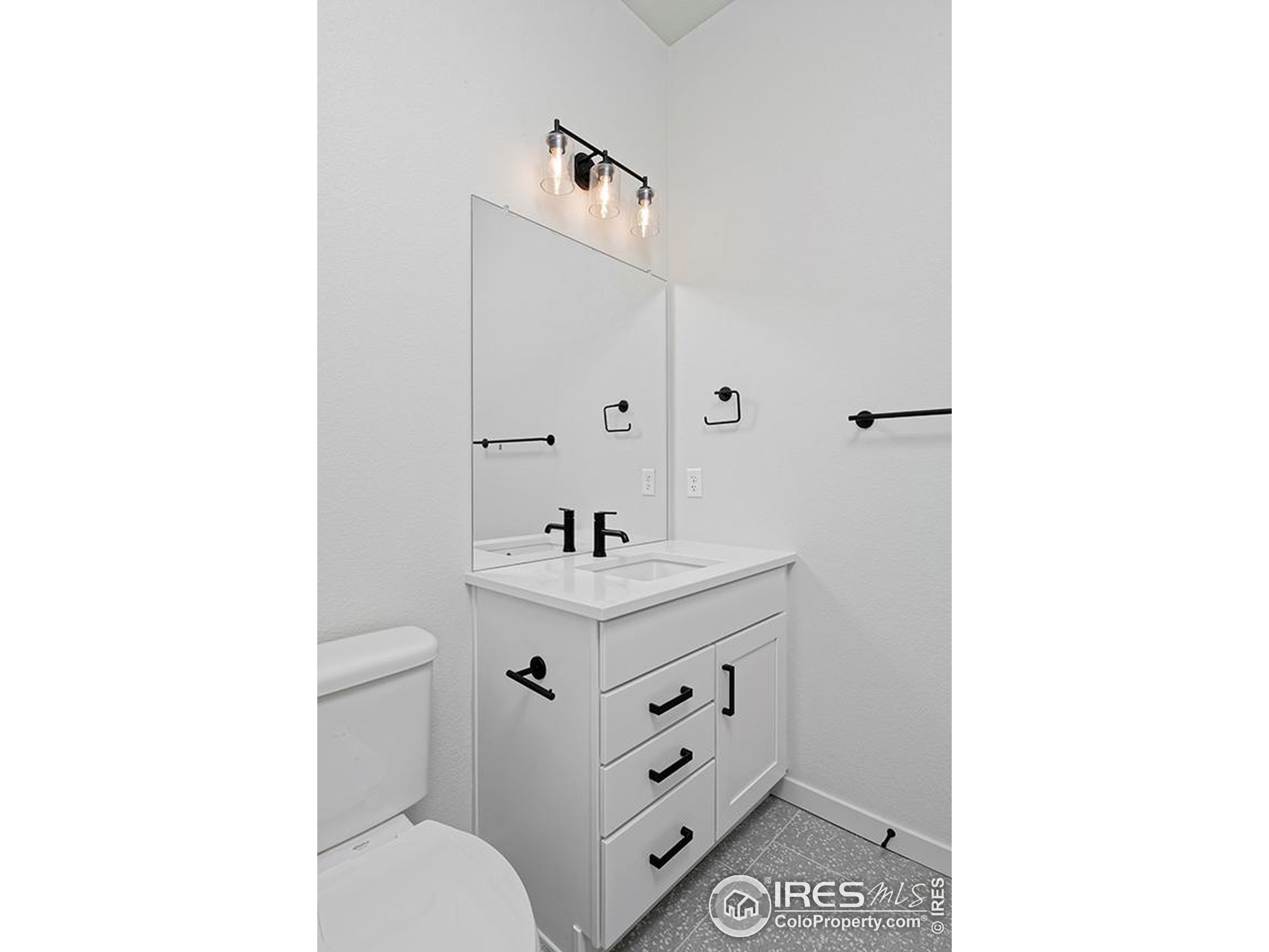 1738 Morningstar Way Fort Collins, CO 80524 - Photo 20 of 49 a bathroom with a toilet sink and mirror