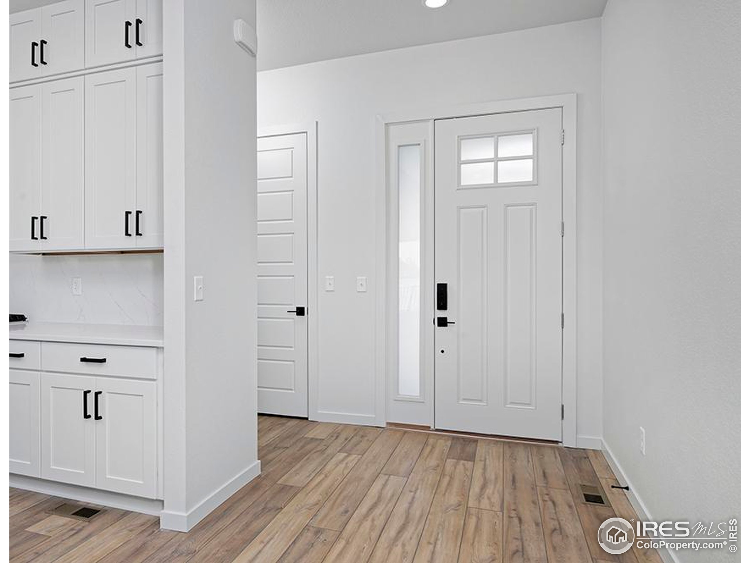 1738 Morningstar Way Fort Collins, CO 80524 - Photo 2 of 49 a view of an entryway with wooden floor
