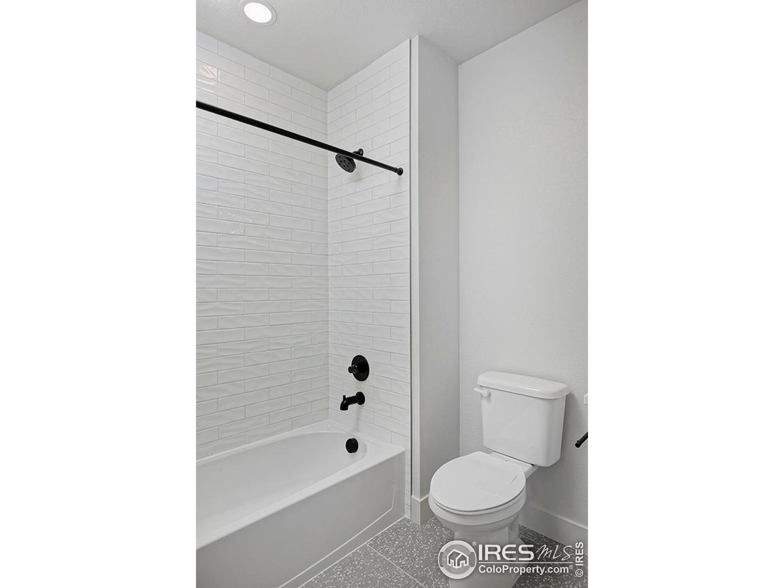 1738 Morningstar Way Fort Collins, CO 80524 - Photo 39 of 49 a white toilet sitting next to a bath tub and a shower