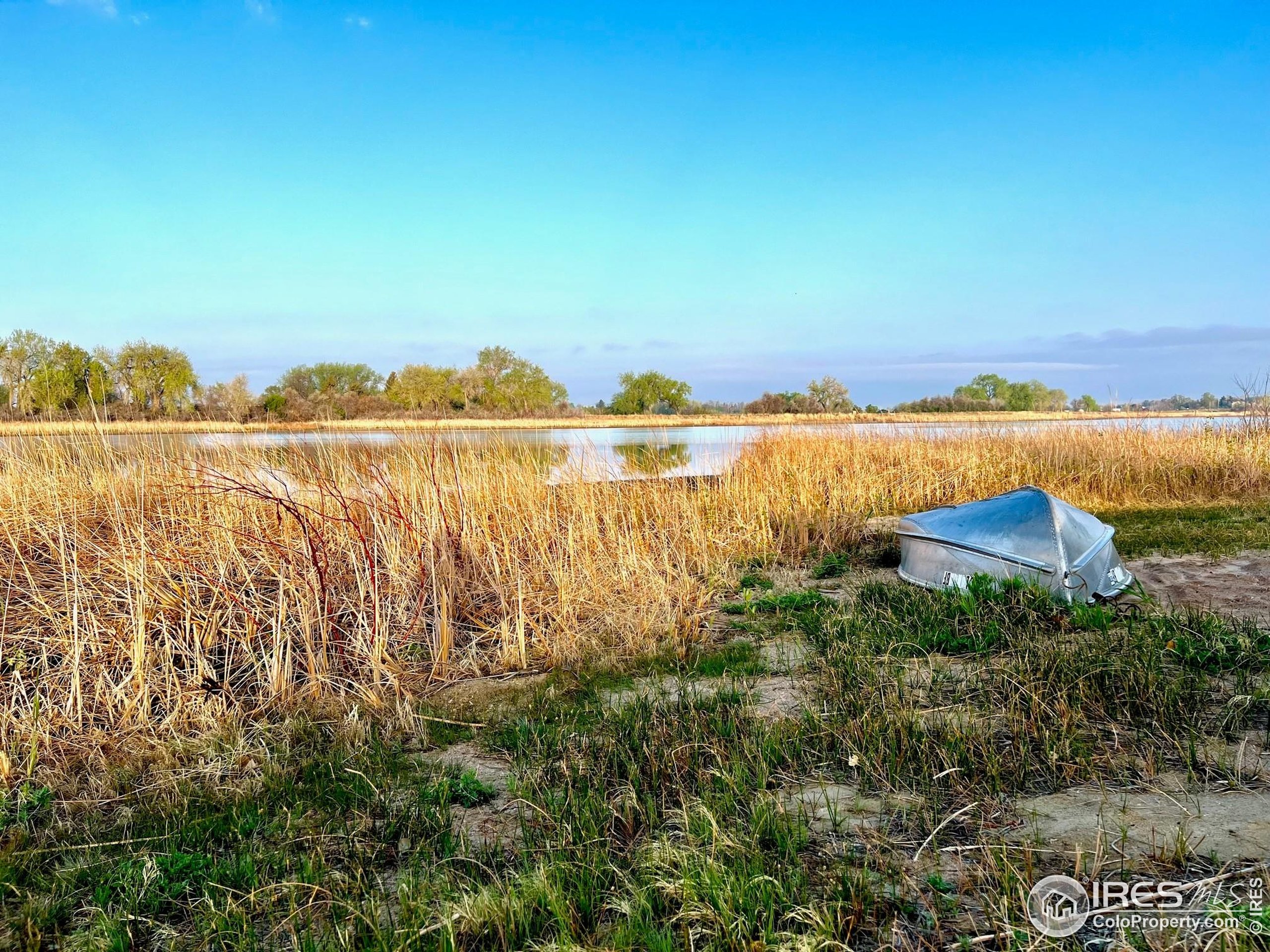 1738 Morningstar Way Fort Collins, CO 80524 - Photo 44 of 49 a view of a lake with a city view