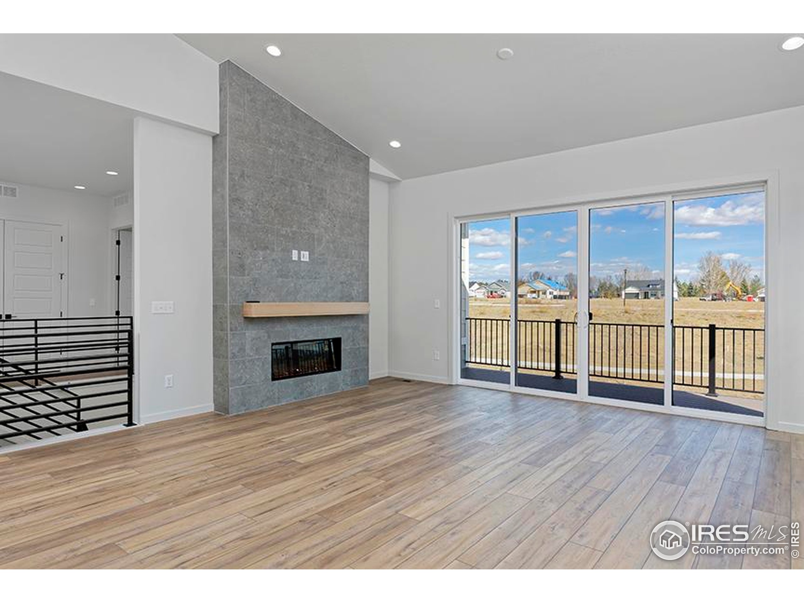 1738 Morningstar Way Fort Collins, CO 80524 - Photo 5 of 49 a view of an empty room with wooden floor and a window
