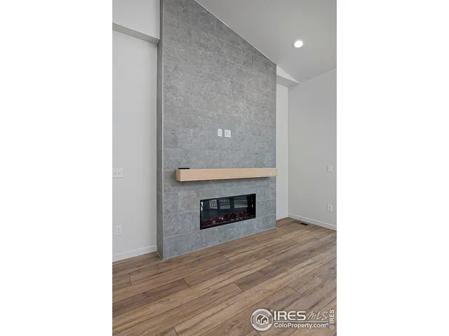 a view of an empty room with fire place
