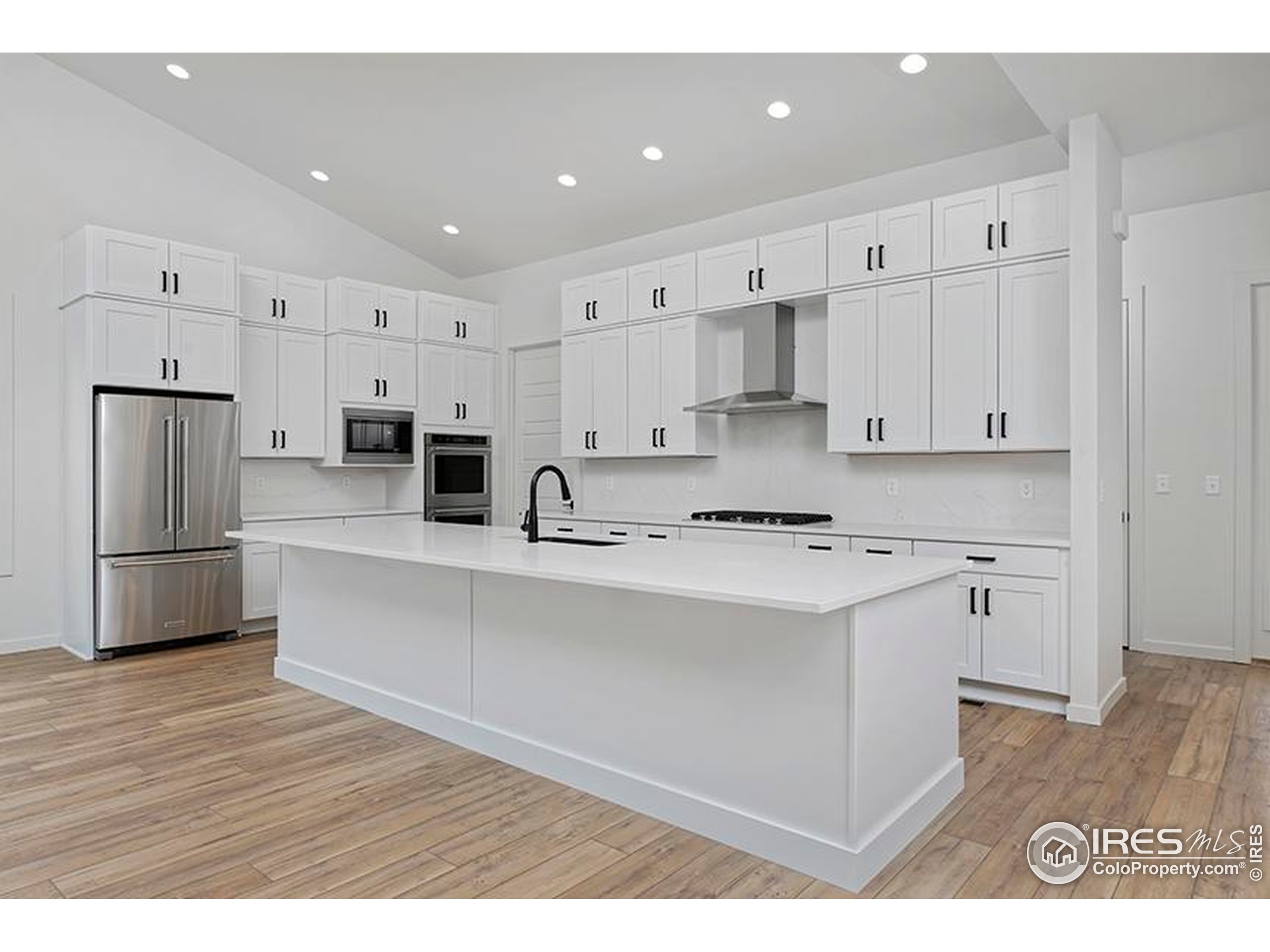 1738 Morningstar Way Fort Collins, CO 80524 - Photo 10 of 49 a kitchen with stainless steel appliances a refrigerator sink and white cabinets