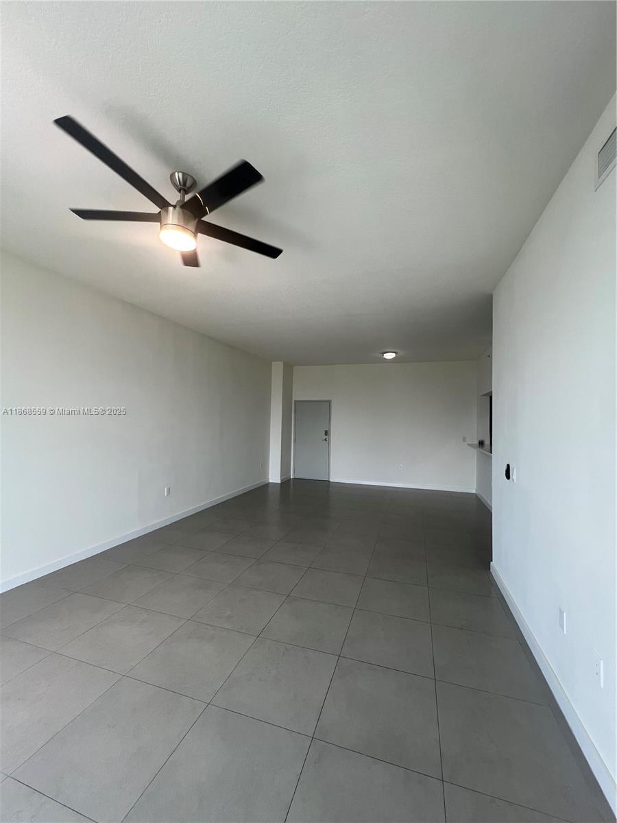 729 Northwest 2nd Street, Unit 1225 Miami, FL 33128 - Photo 6 of 18 a view of a big room with a ceiling fan