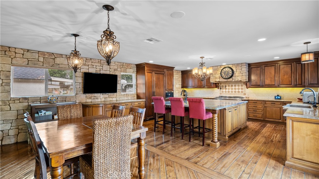 24604 Apple Street Newhall, CA 91321 - Photo 17 of 47 a view of kitchen with sink dining table and chairs