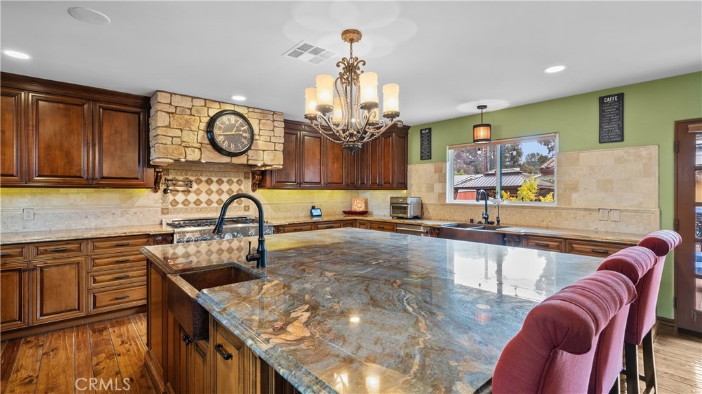 24604 Apple Street Newhall, CA 91321 - Photo 20 of 47 a kitchen with stainless steel appliances granite countertop a sink and a stove