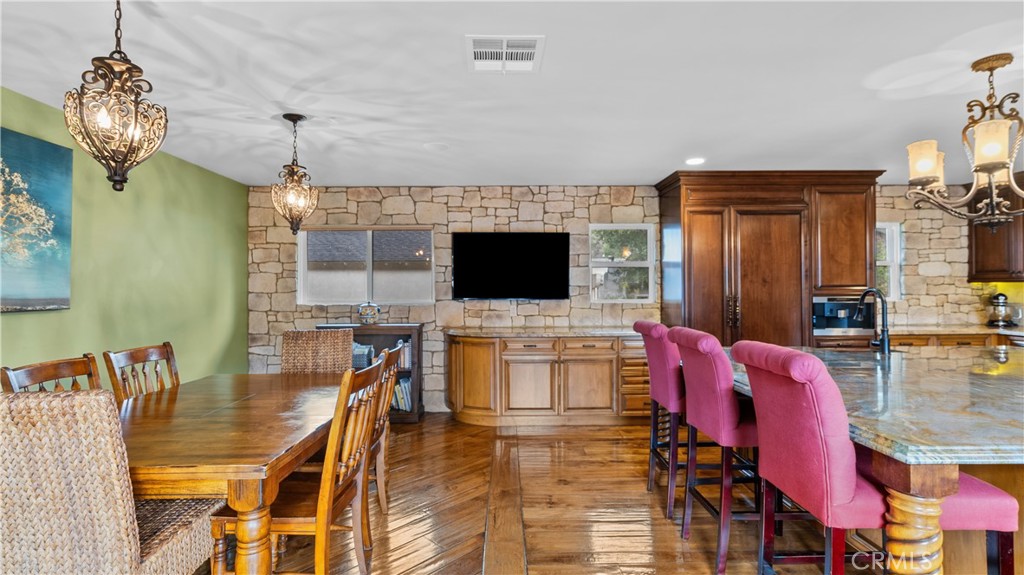 24604 Apple Street Newhall, CA 91321 - Photo 21 of 47 a living room with furniture a flat screen tv and kitchen view