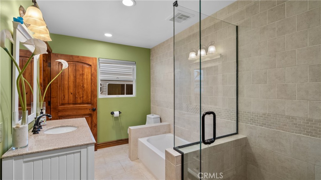 24604 Apple Street Newhall, CA 91321 - Photo 22 of 47 a bathroom with a sink a toilet and mirror