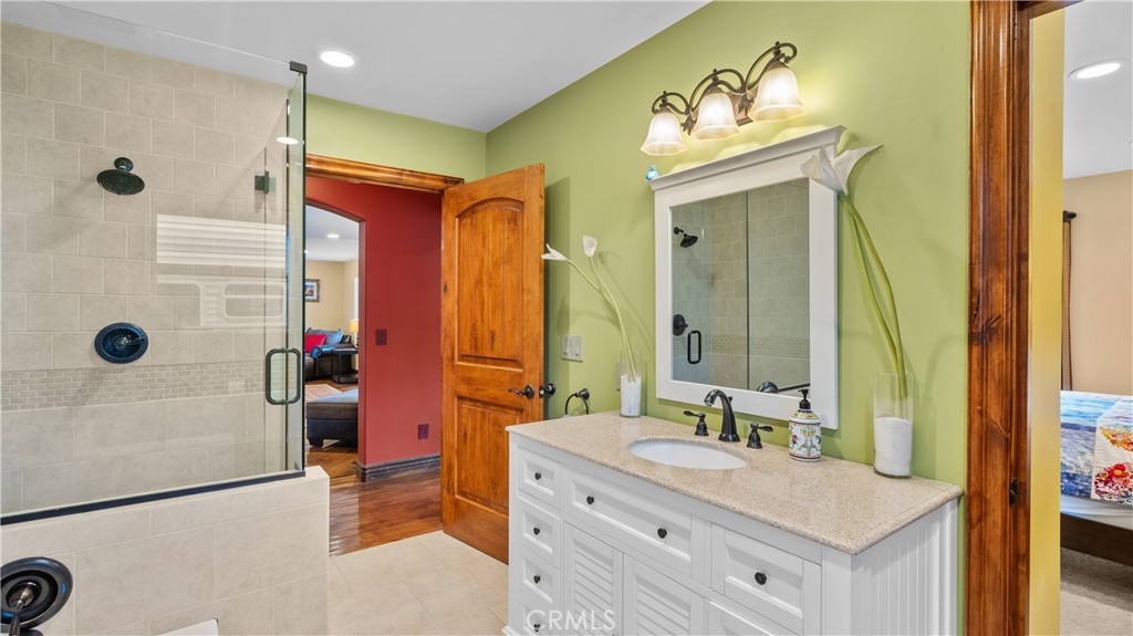 24604 Apple Street Newhall, CA 91321 - Photo 23 of 47 a bathroom with a tub sink and mirror