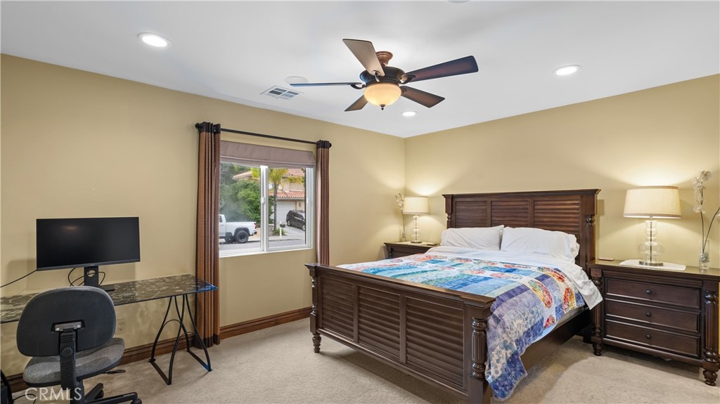 24604 Apple Street Newhall, CA 91321 - Photo 27 of 47 a bedroom with a bed and a flat screen tv