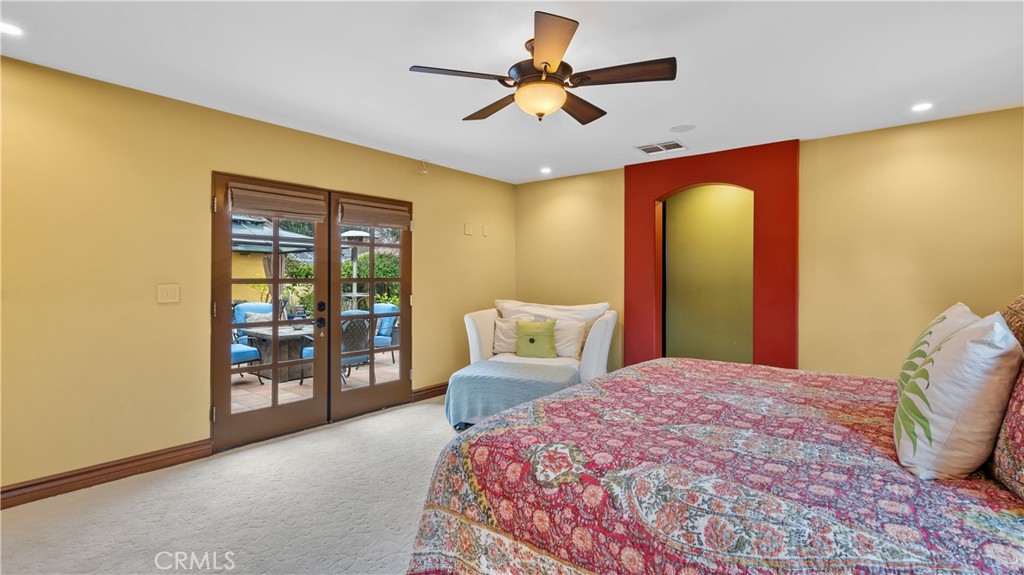 24604 Apple Street Newhall, CA 91321 - Photo 34 of 47 a bedroom with a large bed and a chandelier