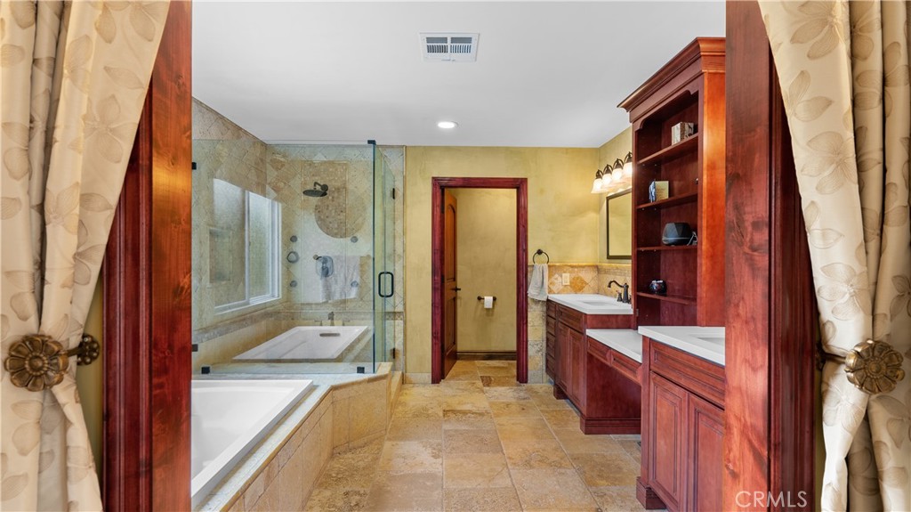24604 Apple Street Newhall, CA 91321 - Photo 35 of 47 a spacious bathroom with a bathtub and a sink