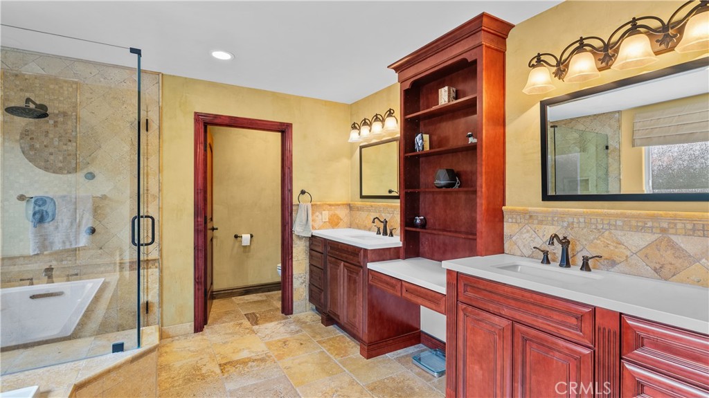 24604 Apple Street Newhall, CA 91321 - Photo 36 of 47 a spacious bathroom with a double vanity sink a mirror a bathtub and shower