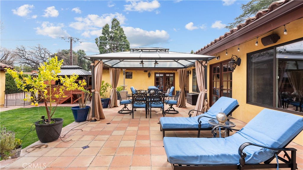 24604 Apple Street Newhall, CA 91321 - Photo 38 of 47 a view of a patio with dining table and chairs