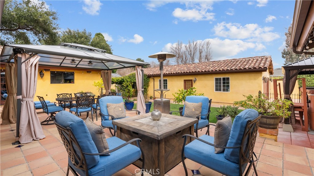 24604 Apple Street Newhall, CA 91321 - Photo 39 of 47 a view of a patio with table and chairs