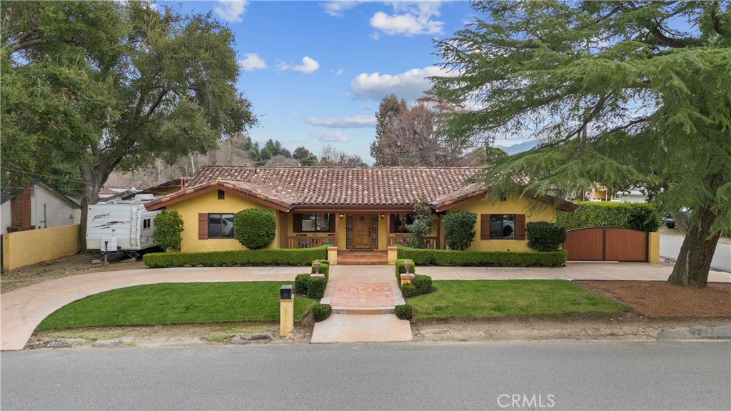 24604 Apple Street Newhall, CA 91321 - Photo 5 of 47 a front view of a house with a yard and garage