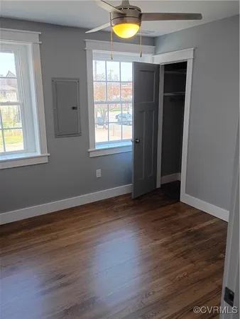 an empty room with wooden floor and a window