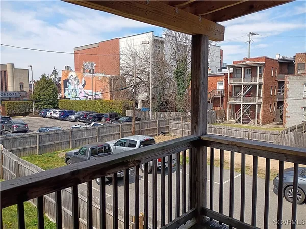 a view of a balcony with wooden floor and fence