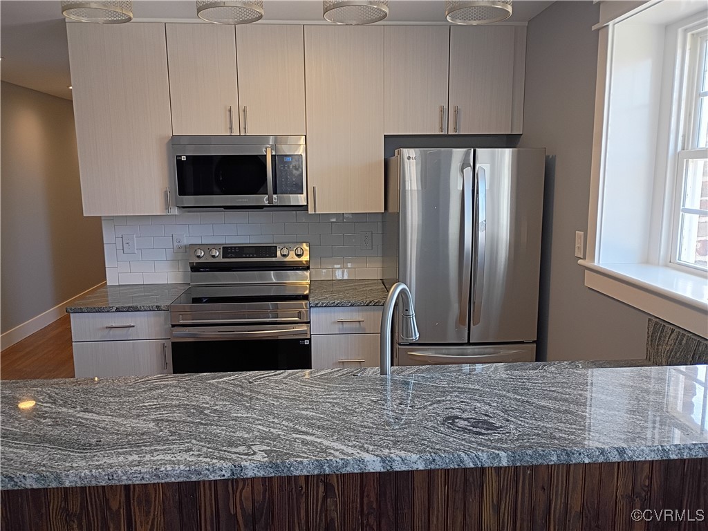 516 North 3rd Street, Unit 3 Richmond, VA 23219 - Photo 4 of 14 Kitchen featuring wood finished floors, dark stone