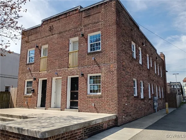 a view of a brick building with many windows