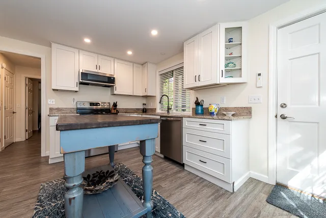 a kitchen with stainless steel appliances a refrigerator sink and cabinets