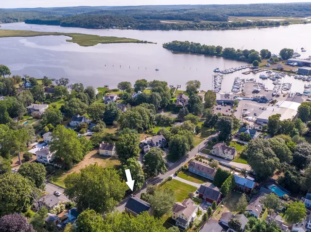 an aerial view of house with outdoor space and lake view