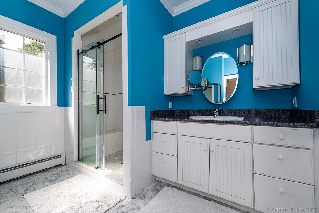 11 North Main Street Essex, CT 06426 - Photo 10 of 35 a bathroom with a sink and a mirror